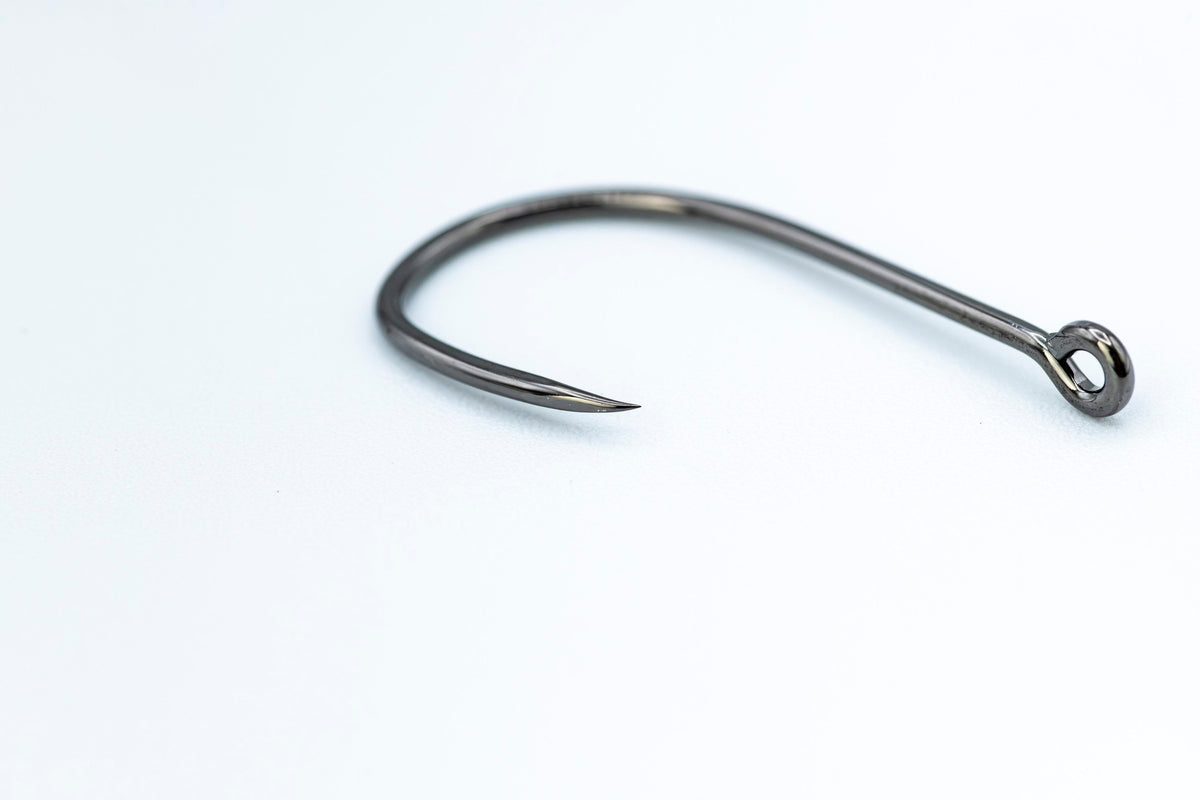 Close-up of a Firehole 801P barbless hook, showing a sharp point with no barb.