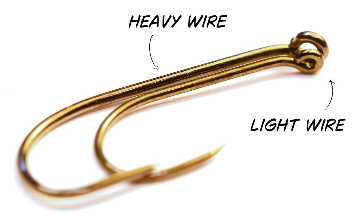 A heavy wire hook and a light wire hook laid together, showing the difference in wire thickness along the shank
